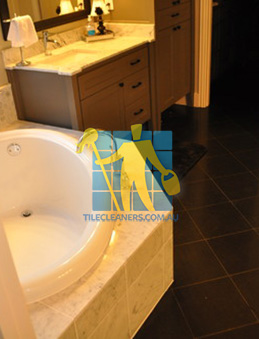 traditional bathroom with black granite tiles on the floor Sydney