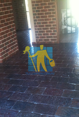large area of slate tiles after sealing with glossy sealer empty room regular pattern Sydney